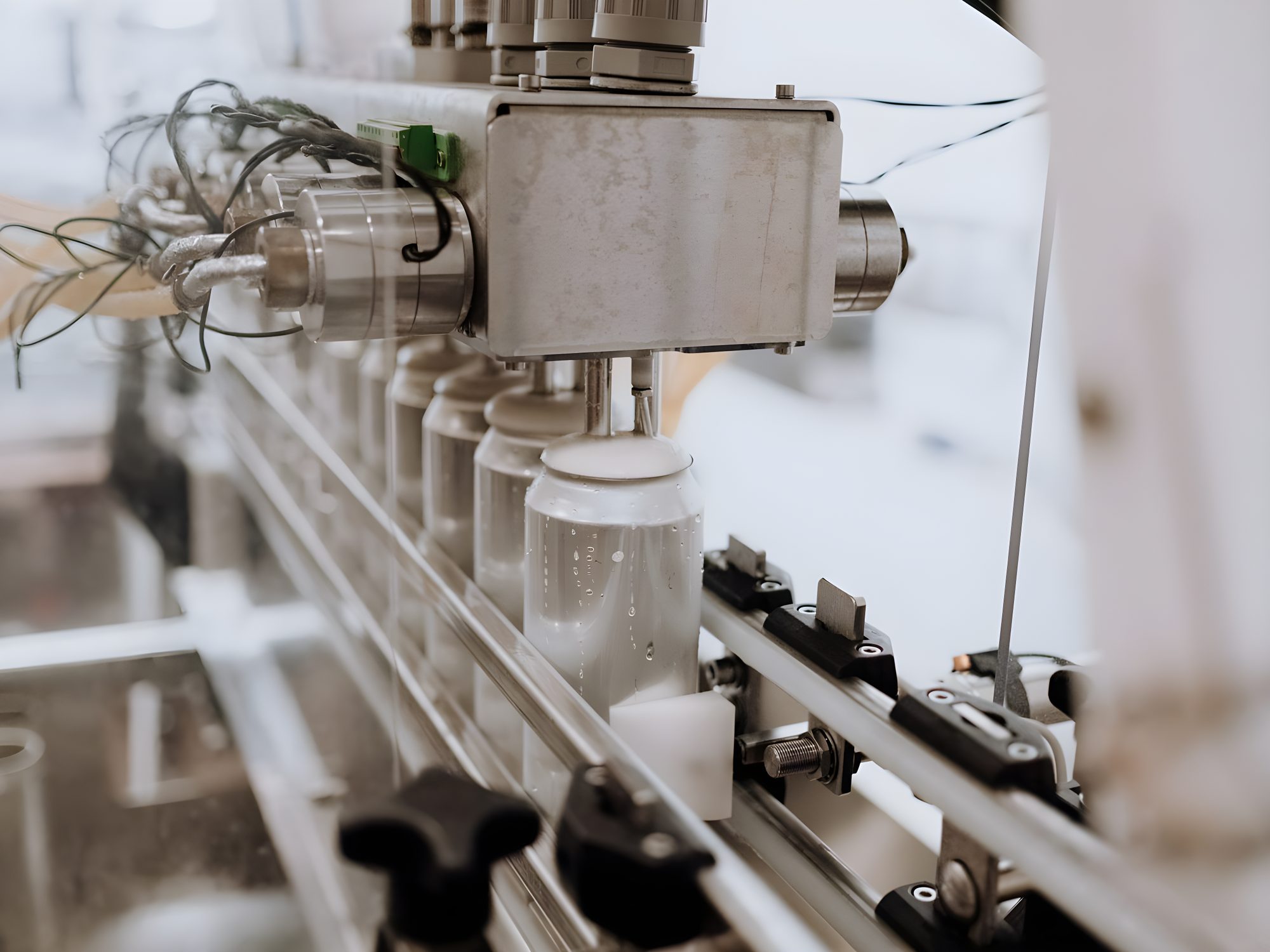 Stainless steel automated beverage can filling line with industrial sensors and sealed fittings in a food processing facility